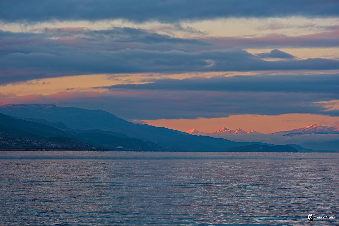 Lake Ohrid at sunset with snow-capped peaks